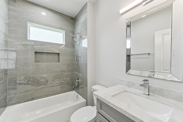 full bathroom with vanity, tiled shower / bath combo, and toilet