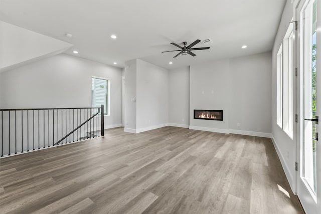 unfurnished living room with ceiling fan and light hardwood / wood-style flooring