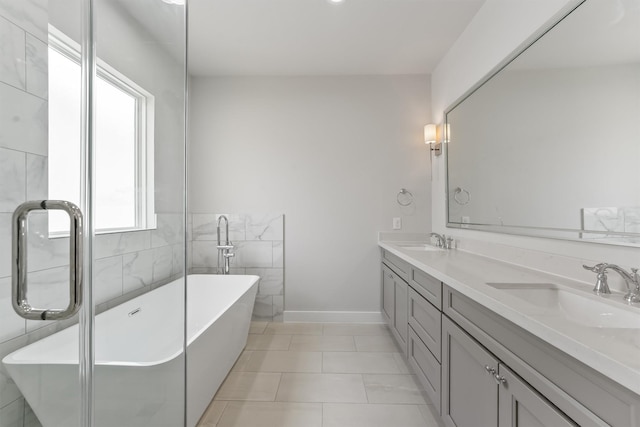 bathroom featuring a tub to relax in, tile patterned floors, vanity, and tile walls