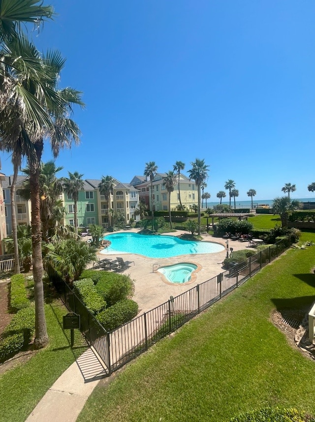 view of swimming pool featuring a lawn and a patio area