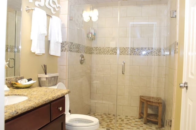 bathroom featuring walk in shower, vanity, and toilet