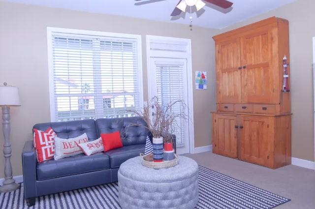 carpeted living room with a wealth of natural light and ceiling fan