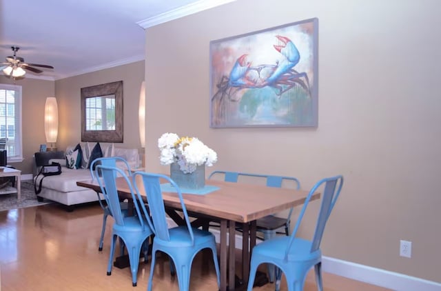 dining area with ceiling fan, hardwood / wood-style flooring, and ornamental molding