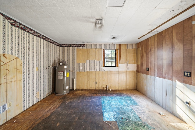 interior space featuring electric water heater, dark hardwood / wood-style floors, and wood walls