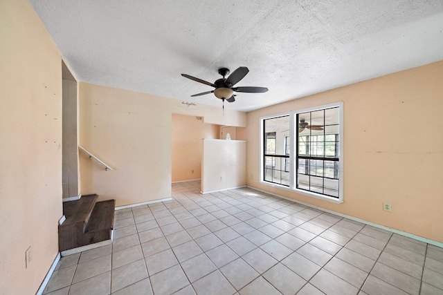 unfurnished living room with a textured ceiling, light tile patterned floors, and ceiling fan