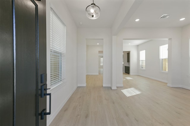 foyer entrance with light hardwood / wood-style flooring