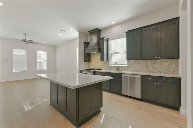 kitchen featuring plenty of natural light, a center island, stainless steel appliances, and custom exhaust hood