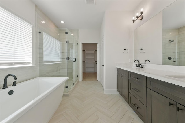 bathroom with vanity and independent shower and bath