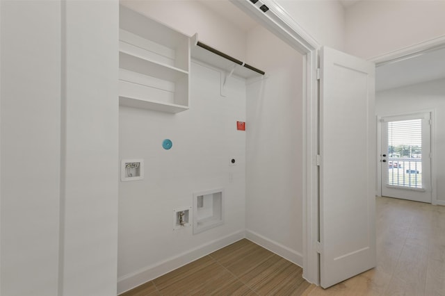 laundry area with washer hookup, electric dryer hookup, and light hardwood / wood-style floors