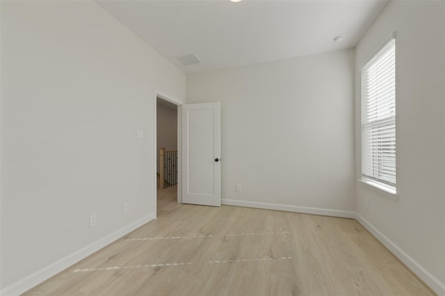 unfurnished room with light hardwood / wood-style floors and plenty of natural light