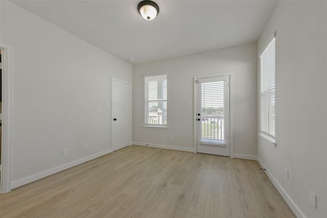 unfurnished room with light hardwood / wood-style flooring