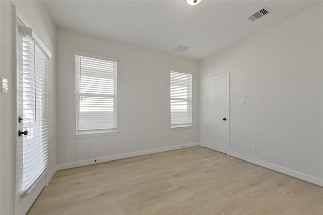 spare room featuring light hardwood / wood-style floors