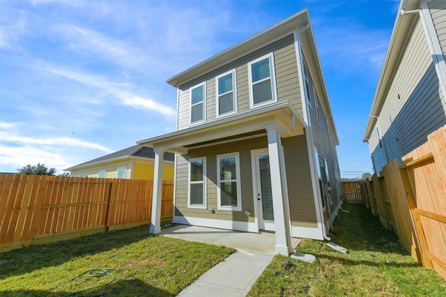 rear view of property with a lawn