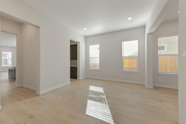 unfurnished room featuring light hardwood / wood-style floors and a healthy amount of sunlight