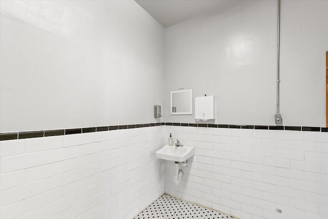 bathroom with tile walls and sink