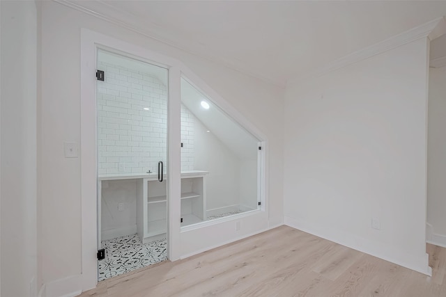 bonus room featuring wood finished floors, vaulted ceiling, and baseboards