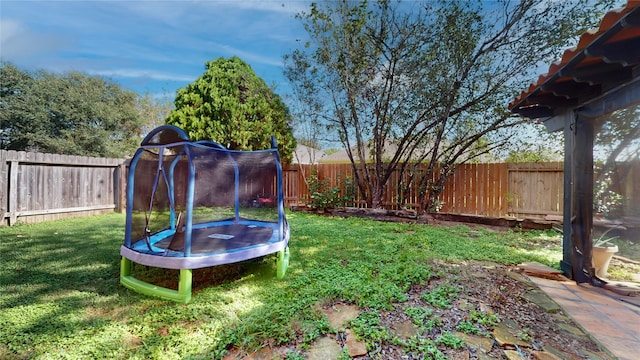 view of yard with a trampoline