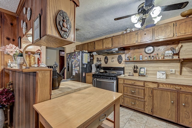 kitchen featuring appliances with stainless steel finishes, a textured ceiling, and ceiling fan