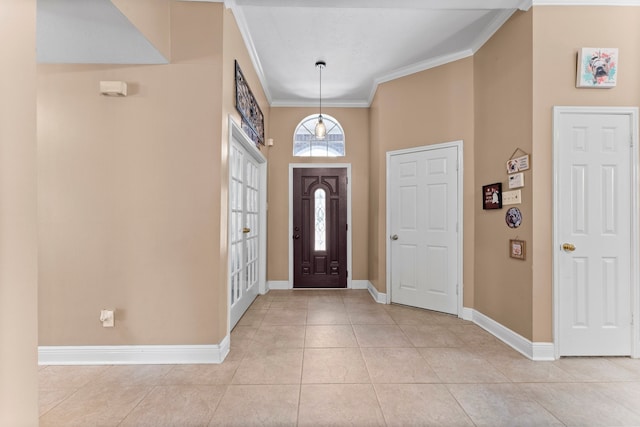 tiled foyer entrance with ornamental molding