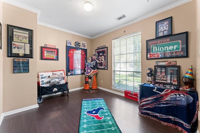 recreation room featuring dark wood-type flooring and ornamental molding