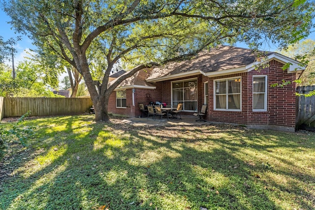 back of house featuring a yard and a patio