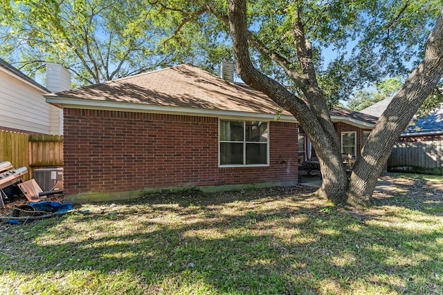 exterior space with a lawn and central AC unit