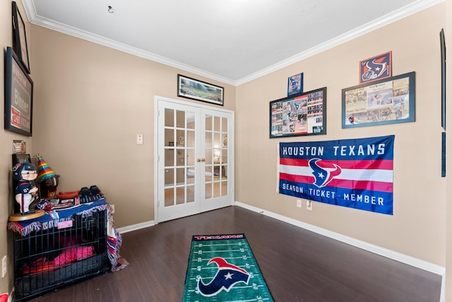 recreation room featuring french doors, crown molding, and dark wood-type flooring