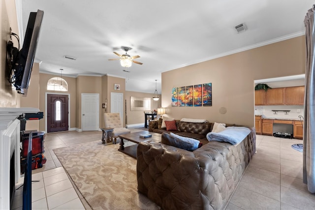 living room featuring ceiling fan, light tile patterned flooring, and ornamental molding