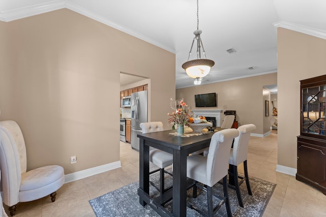 tiled dining space featuring lofted ceiling and crown molding