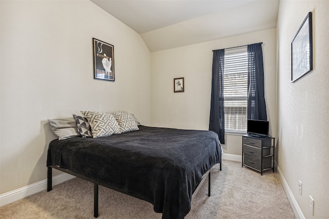 bedroom with vaulted ceiling and light carpet