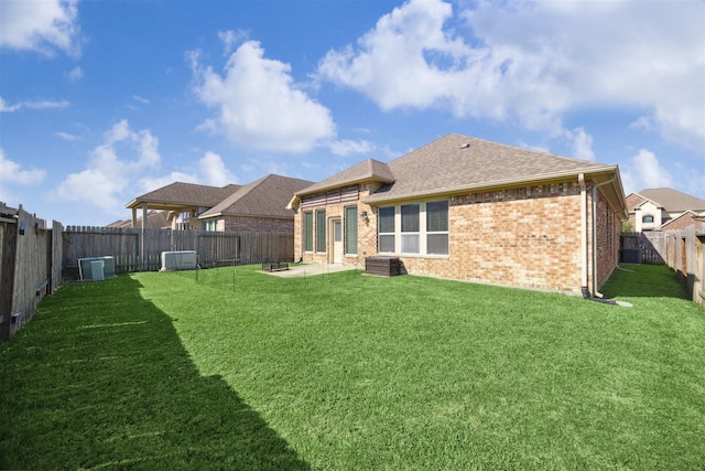 4824 Loures Ln, League City, TX 77573 - back of property with brick siding, roof with shingles, a patio area, and cooling unit