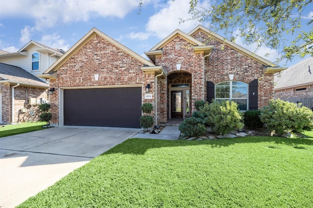 view of front of property featuring a front lawn and a garage