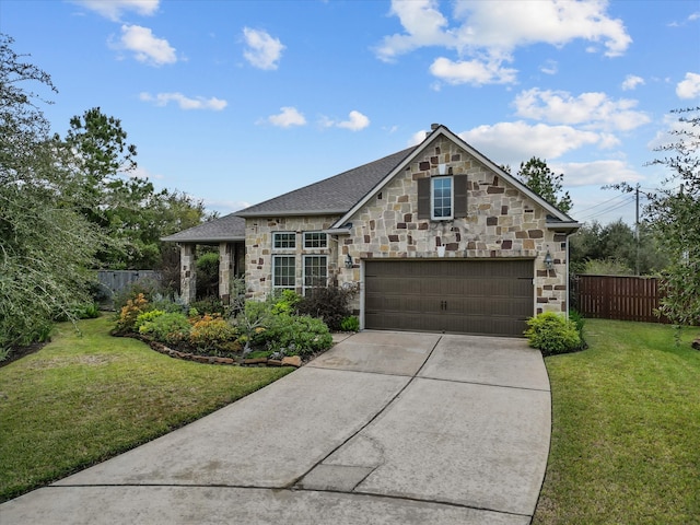 view of front of home with a garage and a front lawn