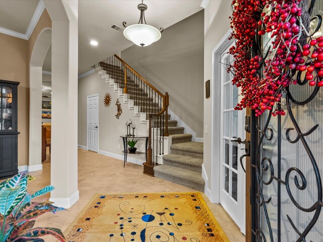 tiled foyer with ornamental molding