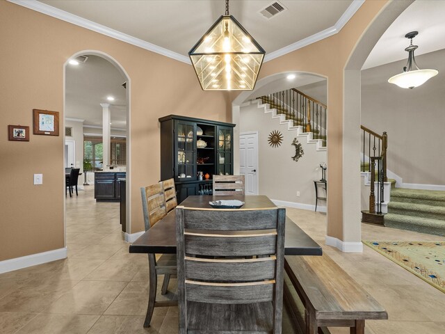 dining space featuring a chandelier, light tile patterned floors, and ornamental molding