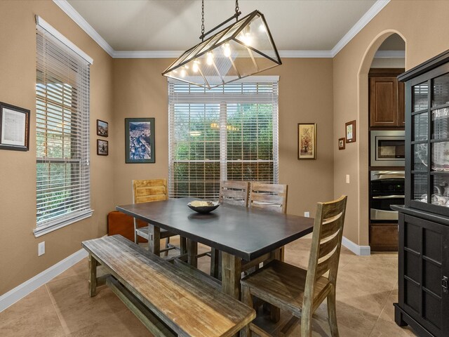 dining space featuring crown molding