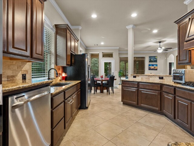 kitchen with appliances with stainless steel finishes, sink, and crown molding