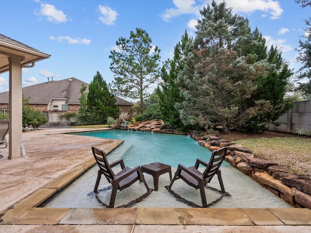 view of swimming pool with a patio