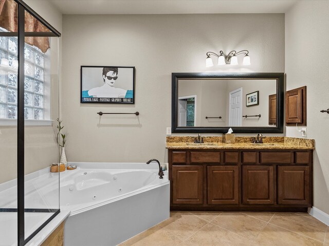 bathroom featuring vanity, tile patterned floors, and a tub