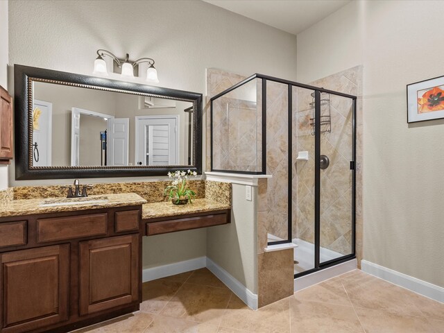 bathroom featuring vanity, an enclosed shower, and tile patterned floors