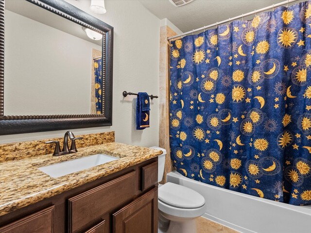 full bathroom featuring vanity, a textured ceiling, toilet, and shower / tub combo