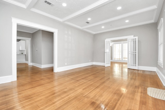 unfurnished living room with crown molding, beamed ceiling, light hardwood / wood-style floors, and a textured ceiling