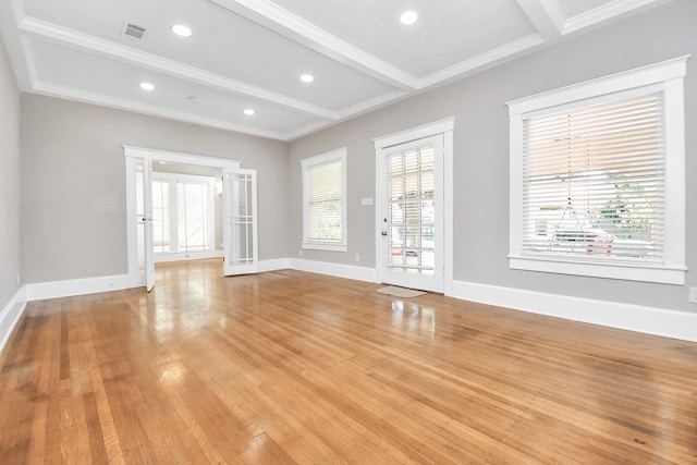 unfurnished living room featuring beam ceiling, light hardwood / wood-style floors, and crown molding