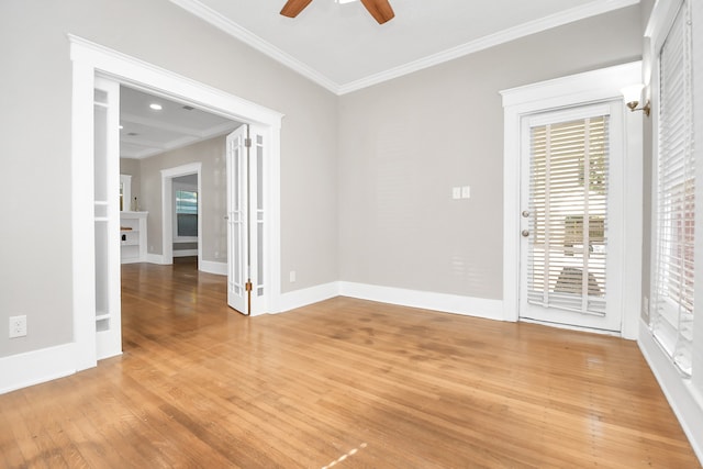 unfurnished room with light hardwood / wood-style flooring, ceiling fan, and crown molding