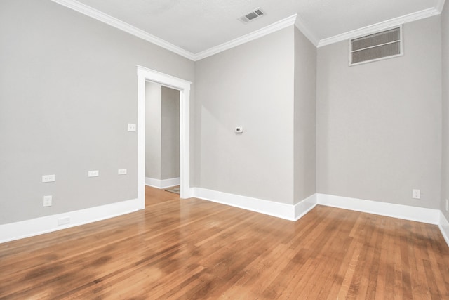 unfurnished room featuring wood-type flooring and ornamental molding