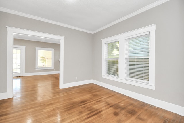 empty room featuring light hardwood / wood-style floors and crown molding