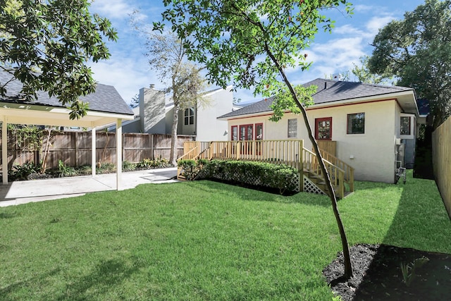 view of yard featuring a patio and a deck