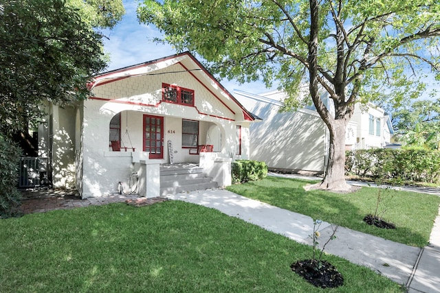 view of front of home featuring a front yard and covered porch