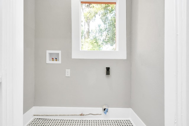 laundry room featuring washer hookup and plenty of natural light