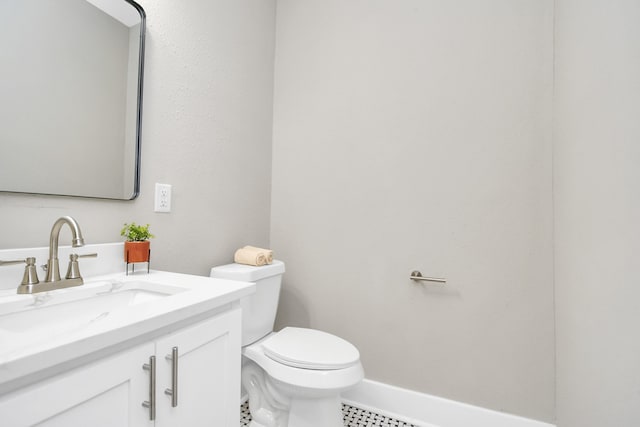 bathroom with tile patterned flooring, vanity, and toilet